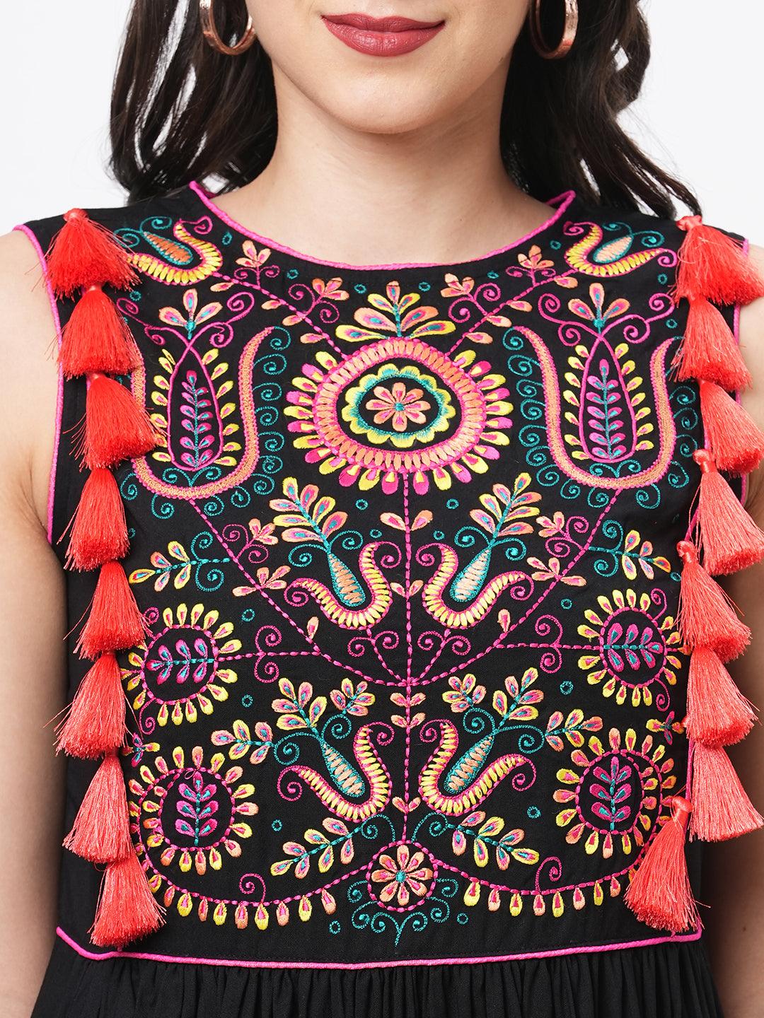 Hashtag Be Featuring a black boho calf length airy dress with tassel and embroidery