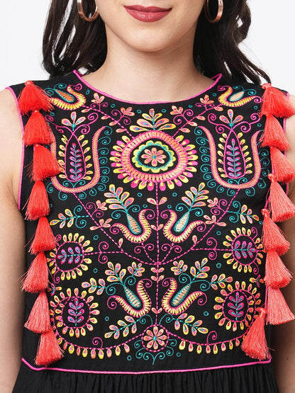 Hashtag Be Featuring a black boho calf length airy dress with tassel and embroidery
