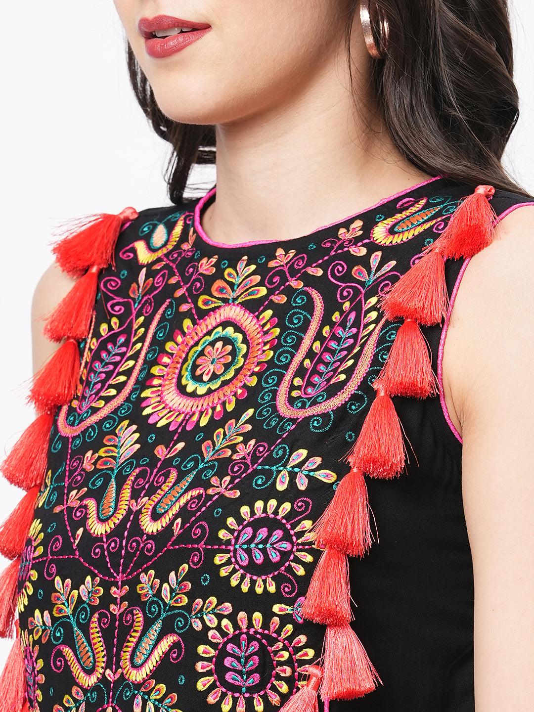 Hashtag Be Featuring a black boho calf length airy dress with tassel and embroidery