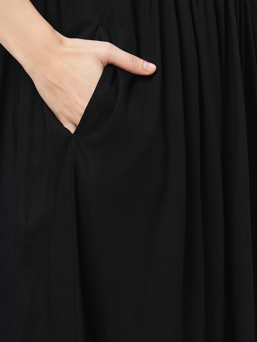 Hashtag Be Featuring a black boho calf length airy dress with tassel and embroidery