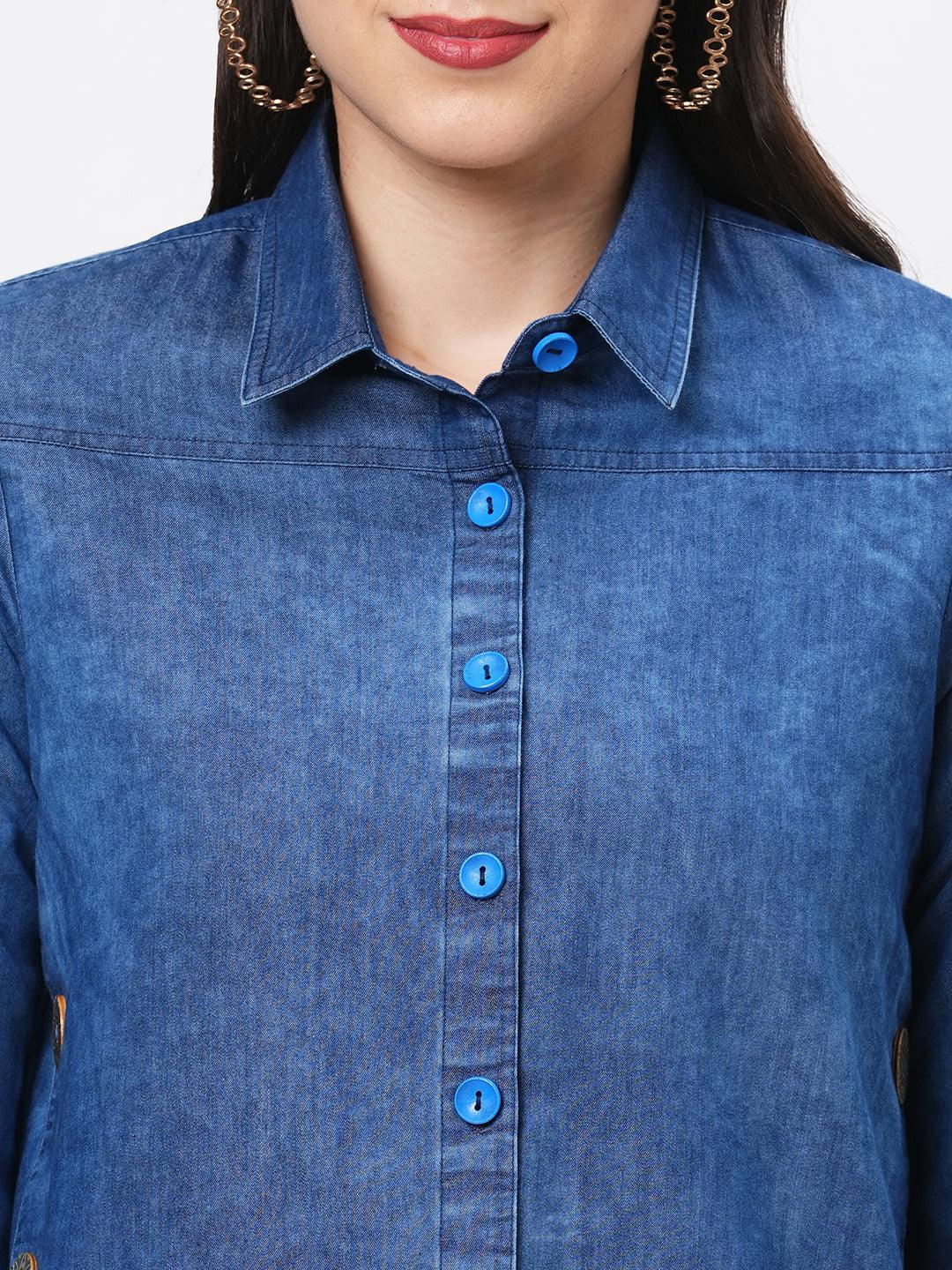 Hashtag Be Denim blue in sturdy washed cotton shirt with collar and button down front and high low hem with embroidery at the back