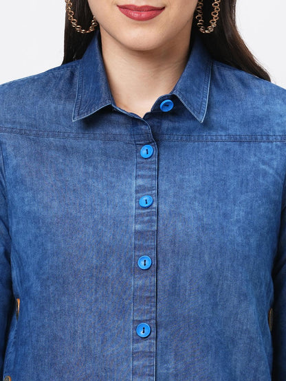 Hashtag Be Denim blue in sturdy washed cotton shirt with collar and button down front and high low hem with embroidery at the back